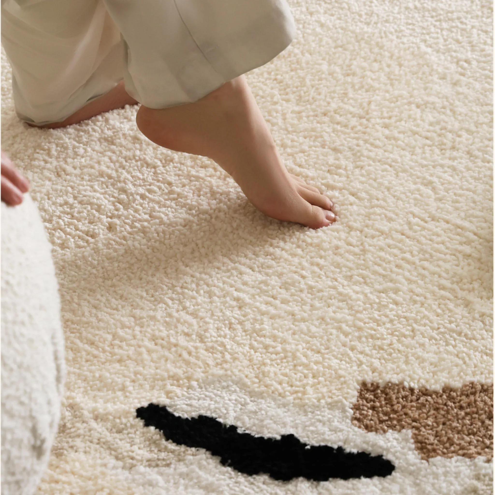 Elodie Cream & Beige Abstract Circle Round Tufted Rug by Housenfriends plush dense pile close-up with foot on soft cream tufted surface