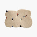 Elodie Cream Flecked Abstract Irregular Tufted Small Rug on a white background