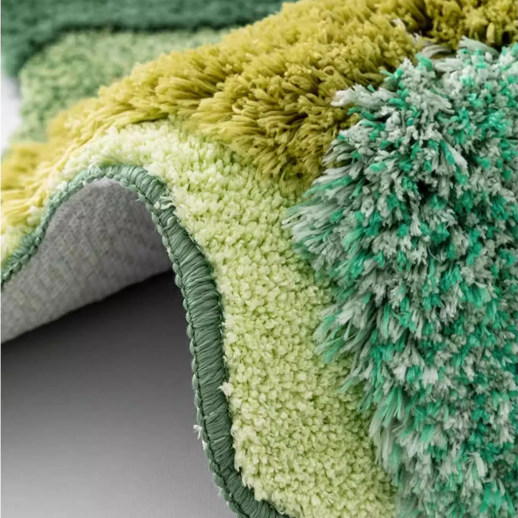 Elowen Mint Green Woodland Tufted Irregular Rug by Housenfriends, bound edge detail with dense mint green fibres and sculpted high low pile
