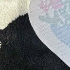 Close-up of texture fabric and a white non-slip backing of Floral Black Cat Shaped Designer Tufted Rug