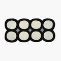 Harper Black and White Irregular Polka Dots Tufted Rug by Housenfriends on a white background