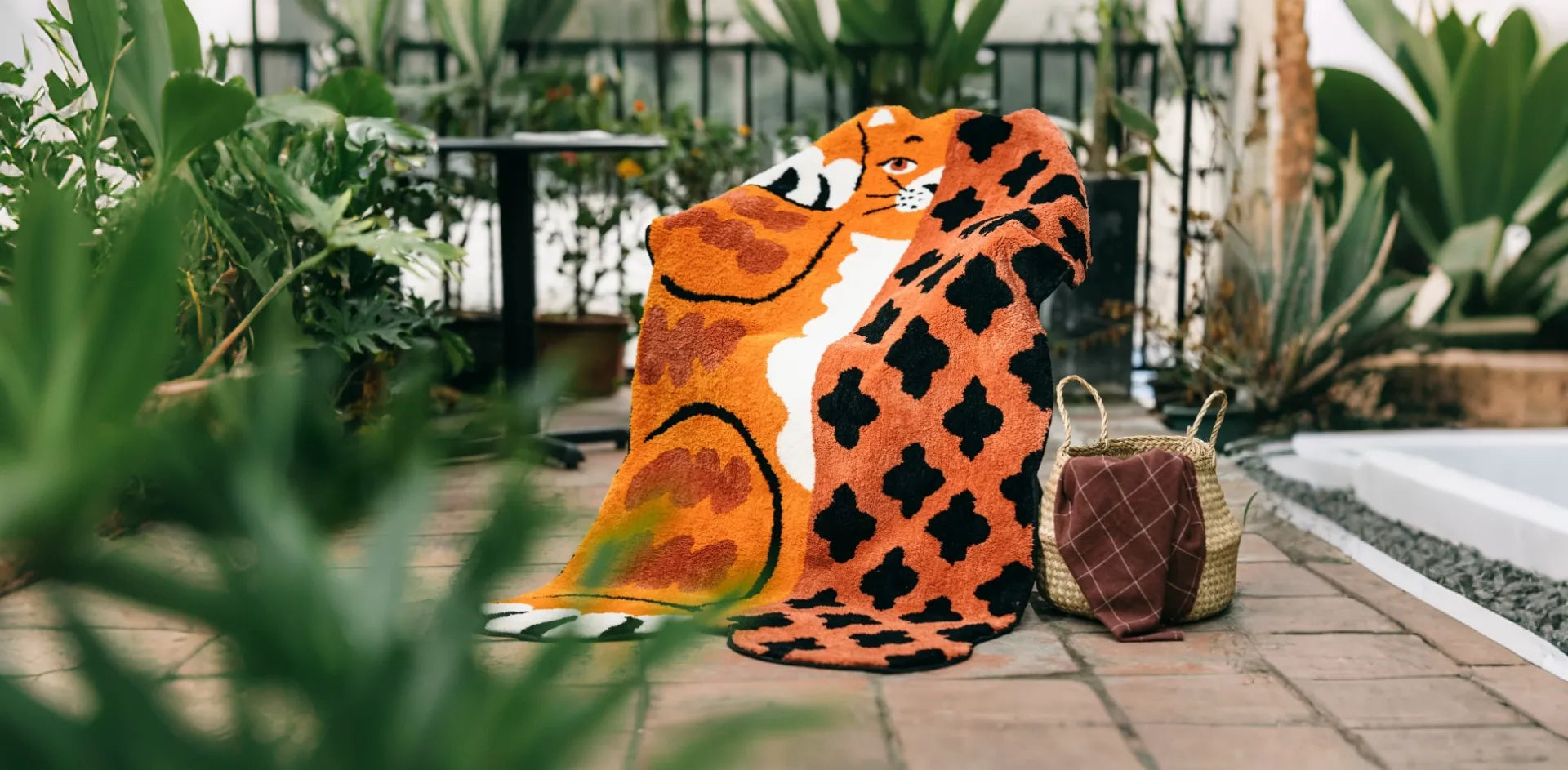 Hide & Seek Orange Whimsical Patchwork Big Cat Shaped Whimsical Rug displayed in a tropical garden