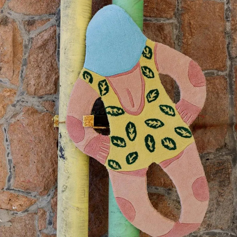 June Yellow Swimsuit Swimming Girl Artistic Graphic Body Art Tufted Rug by Housenfriends hanging by pastel pipes, colourful graphic body art rug with tufted texture