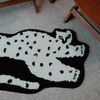 Close-up of the Black Base White Leopard Shaped Tufted Rug on a carpeted floor