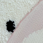 Close-up of a white non-slip backing of the White Leopard Shaped Tufted Rug by Housenfriends
