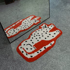 Layla Red Base White Leopard Shaped Tufted Rug in front of a mirror on a grey floor.
