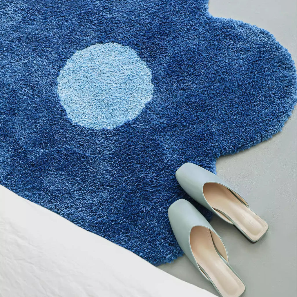 Close-up of Maisie Blue & Pale Blue Floral Shaped Tufted Rug by Housenfriends, floral shaped tufted rug with dense pile and plush texture beside bed