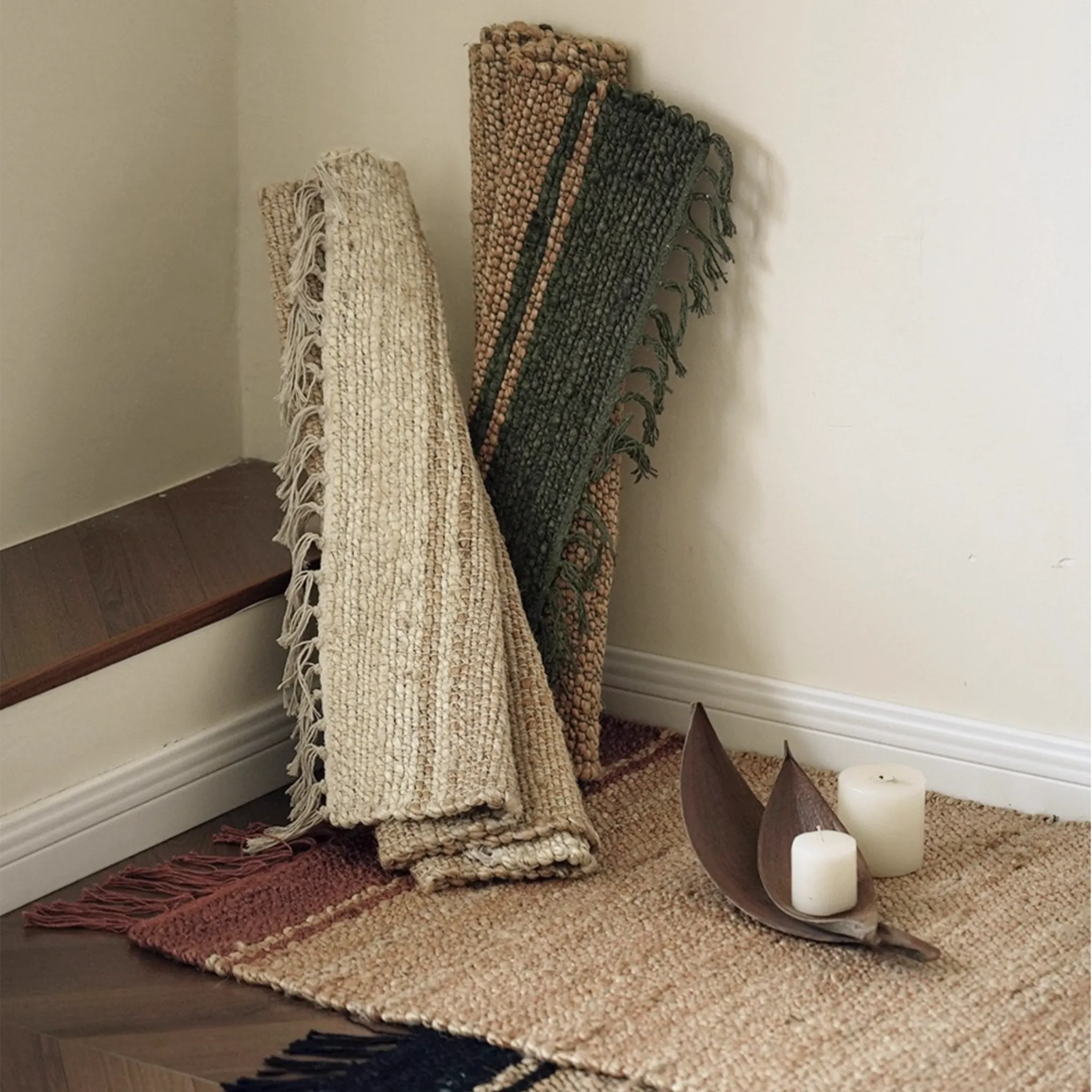 Maren Natural & Terracotta Fringed Handwoven Jute Rug by Housenfriends, rolled jute rug showing flexible flatweave
