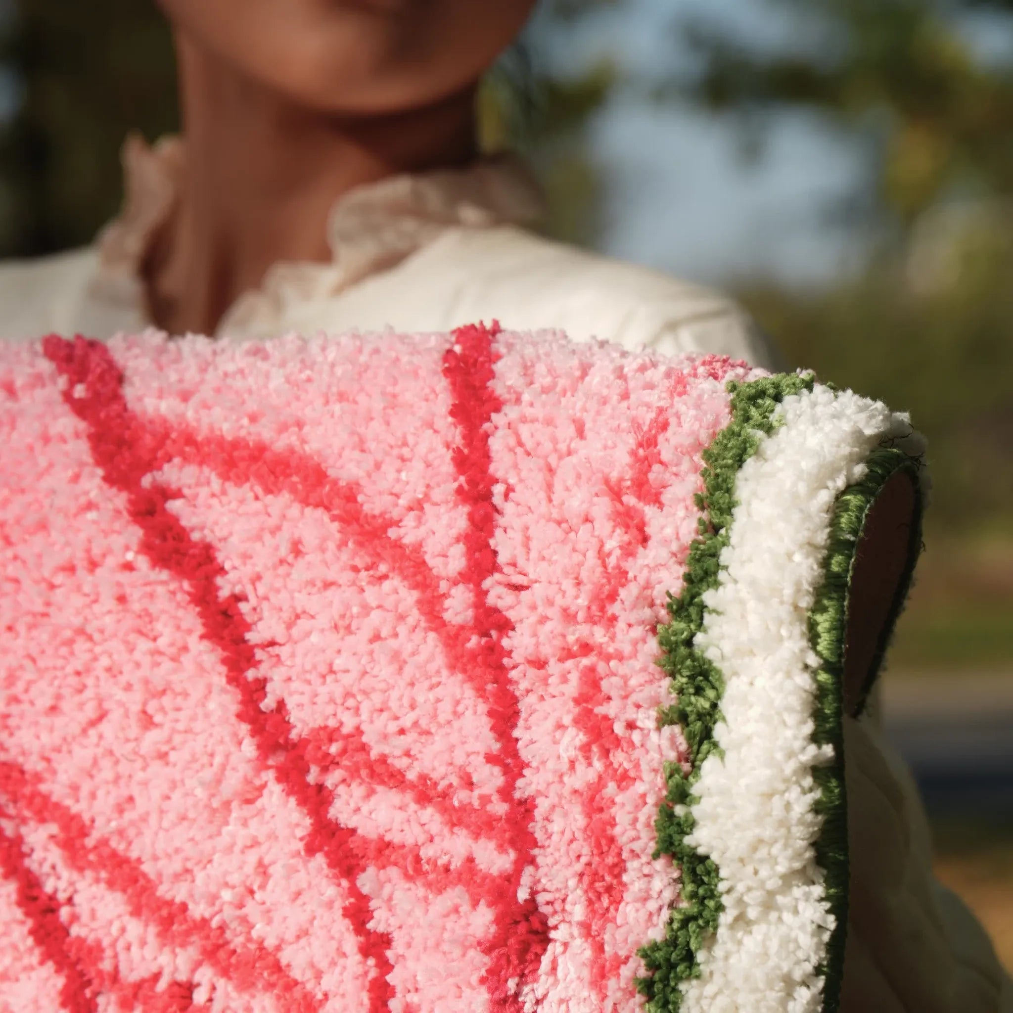 Pink botanical heart leaf shaped tufted rug with raised red veins and green edge by Housenfriends