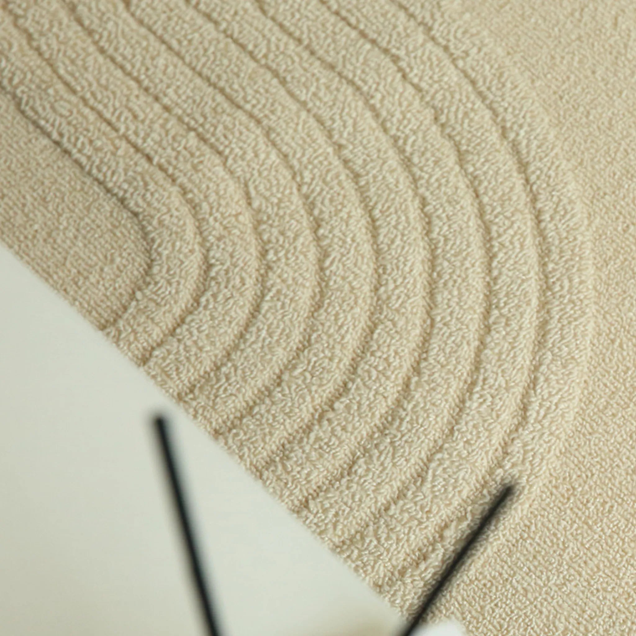 Housenfriends Nori cream rug detail showing curved high-low wave-line texture