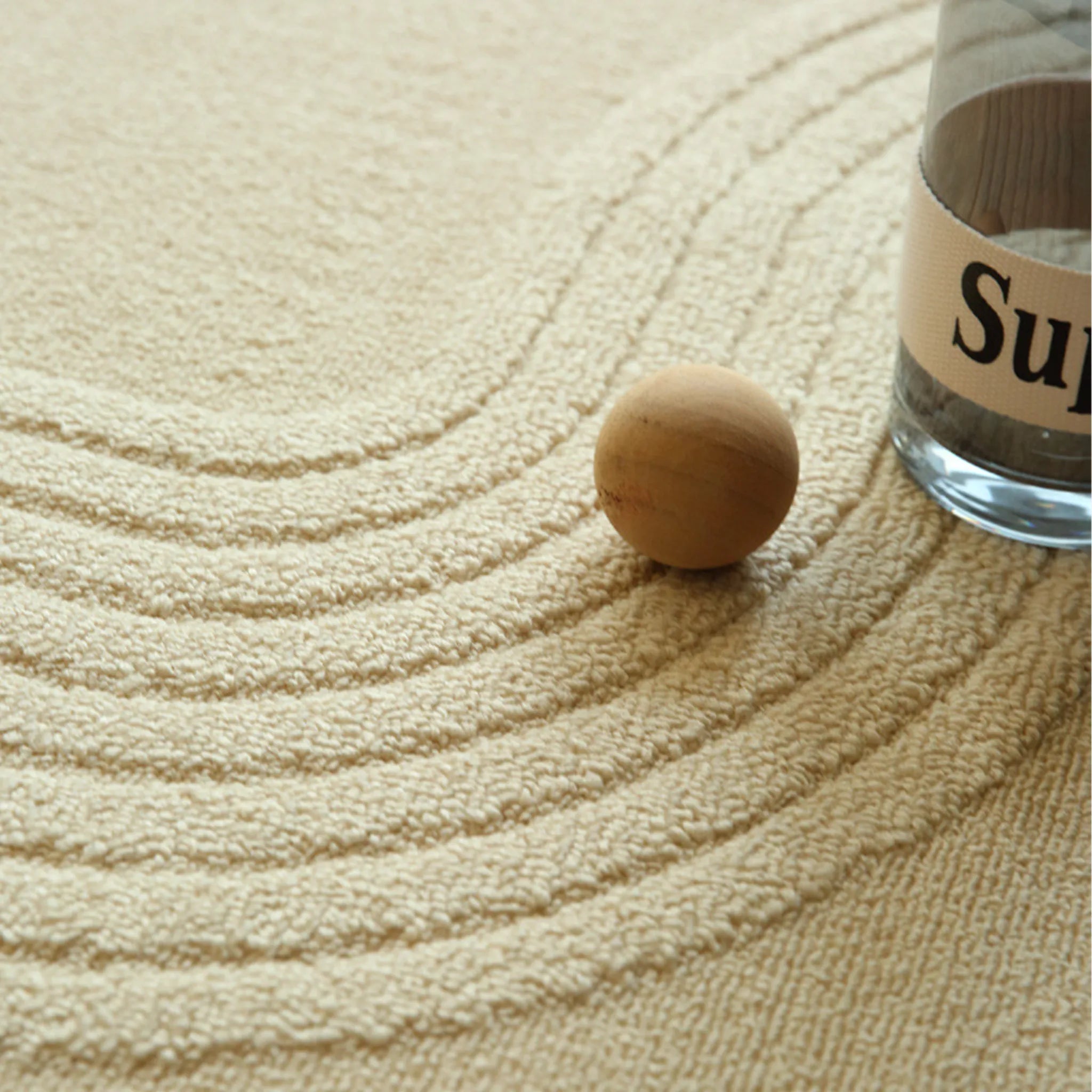 Housenfriends Nori cream rug macro detail with sculpted curved line texture