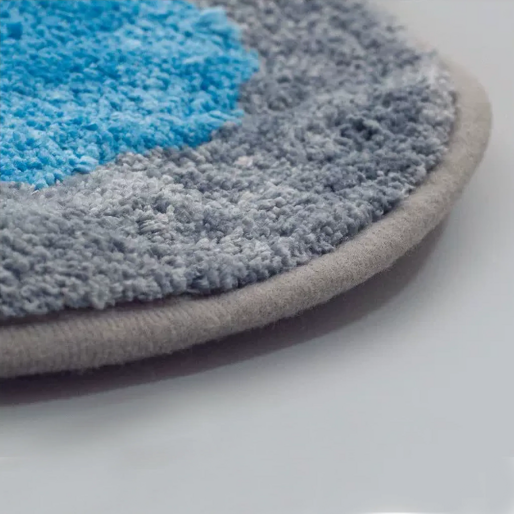 Close-up of Otto orange dog and blue cat tufted rug by Housenfriends with dense pile, grey bound edge and non-slip cotton backing