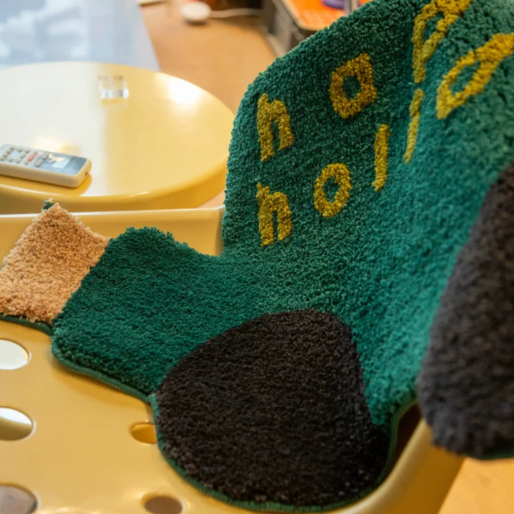 Pip Forest Green & Black Happy Holiday Graphic Car Shaped Tufted Rug by Housenfriends close up, shaggy green car rug with word art and black wheels
