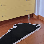 Playful Black Jumping Cat Shaped Designer Tufted Rug by Housenfriends on a wooden floor.