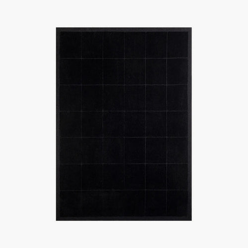 Pure Black Minimalist Modern High Low Hand Tufted Rug by Housenfriends on a white background