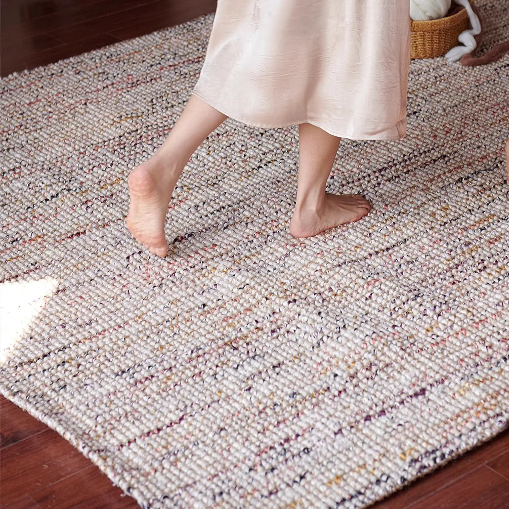 Person walking on Rowan Neutral Multi-Tone Wool & Jute Handwoven Rug