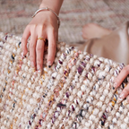 Close-up of a hand with a ring on Neutral Multi-Tone Wool & Jute Handwoven Rug by Housenfriends