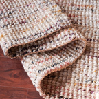 Close-up of Textured area rug on a wooden floor
