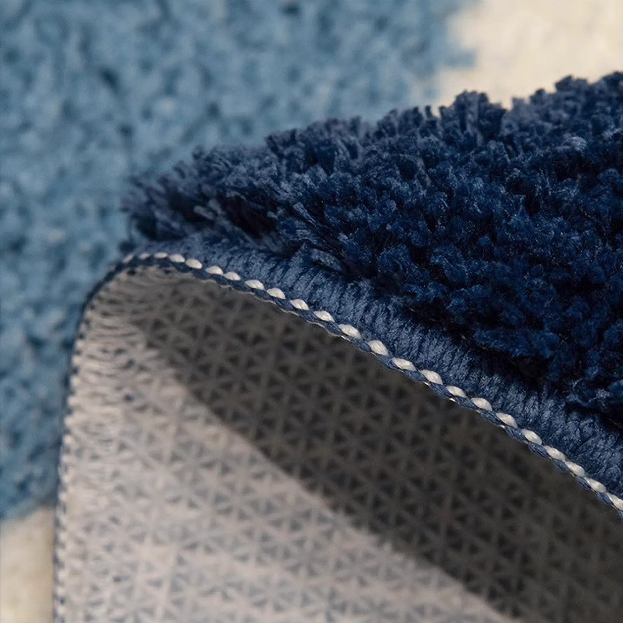 Close-up of a blue texture of Seren Blue & White Half-Moon Cloud Tufted Rug by Housenfriends 