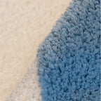 Close-up of a blue texture of Seren Pale Blue & White Half-Moon Cloud Tufted Rug by Housenfriends