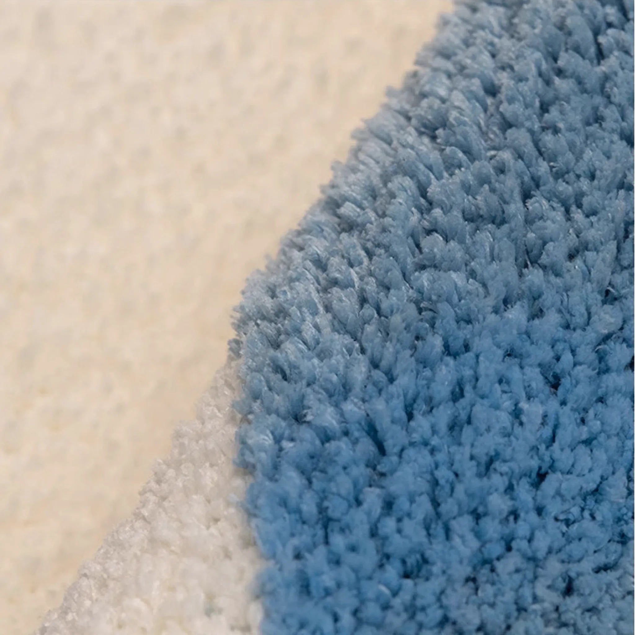 Close-up of a blue texture of Seren Pale Blue & White Half-Moon Cloud Tufted Rug by Housenfriends