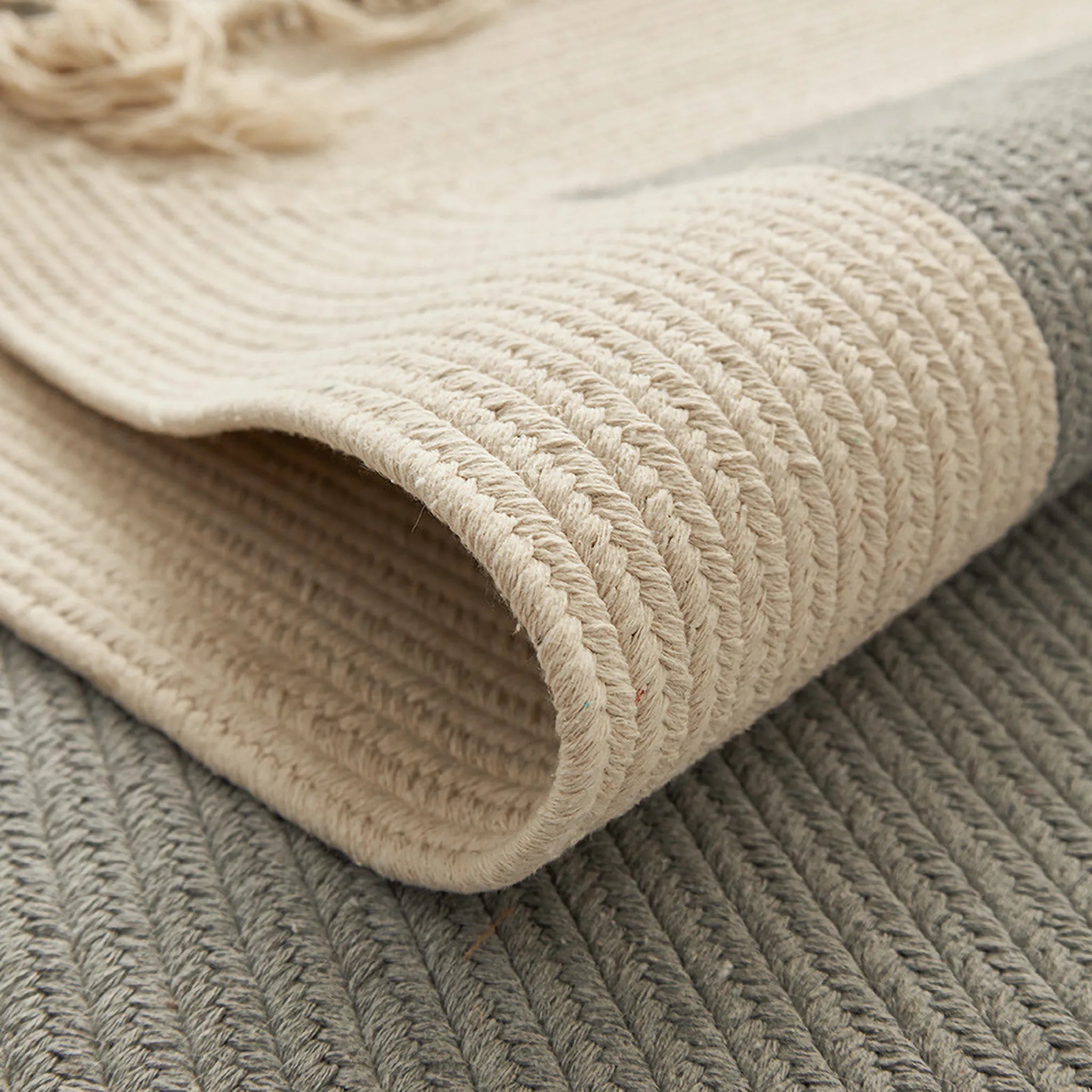 Rolled edge detail showing the thickness and tight hand-braided weave of the Housenfriends Signe cotton-blend rug