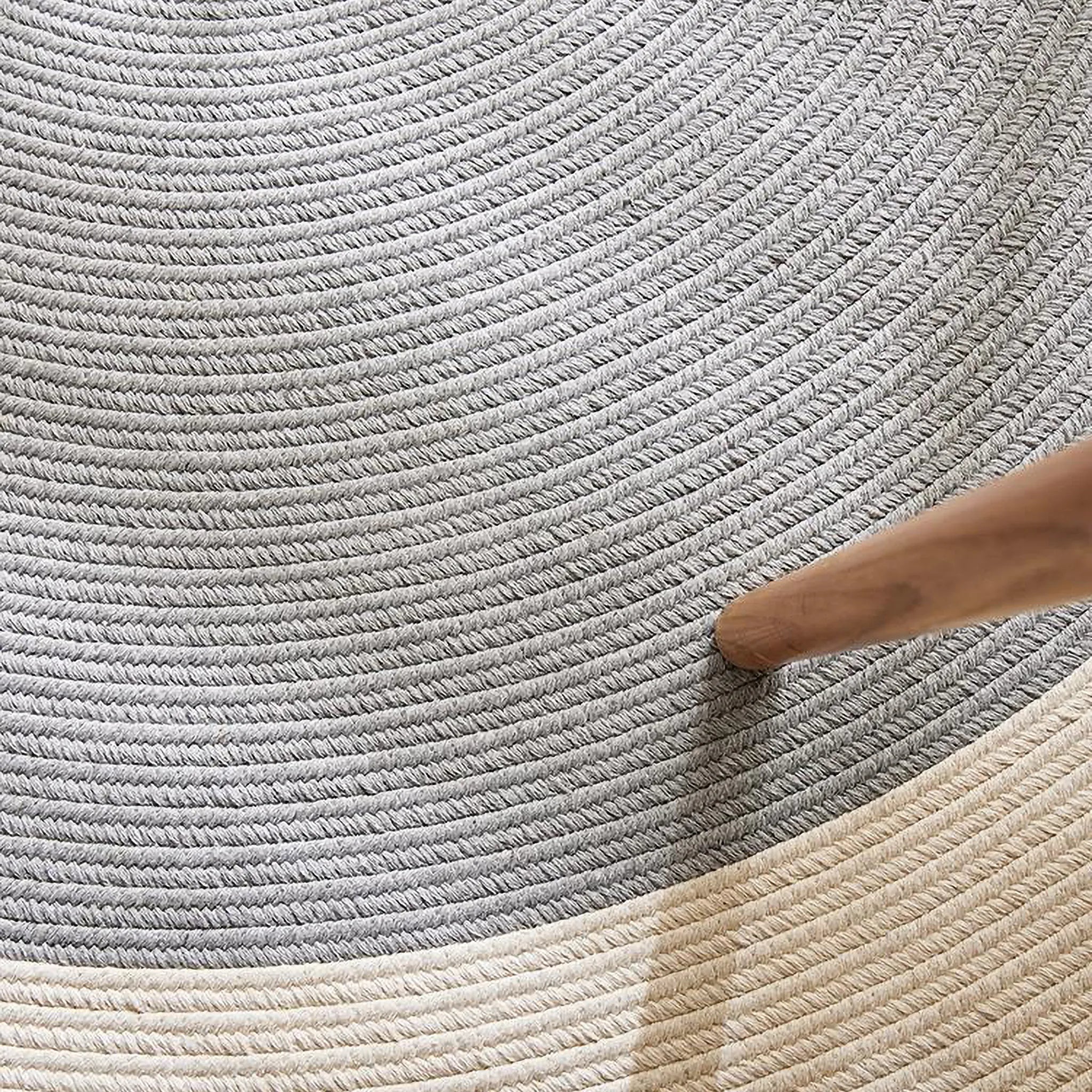 Signe grey and natural round cotton blend rug close-up showing spiral braid weave and tonal contrast by Housenfriends