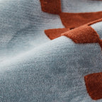 Close-up of Acropolis Slate Blue and Red Tufted Wool Rug by Housenfriends, showing the textured high-low pile detail.