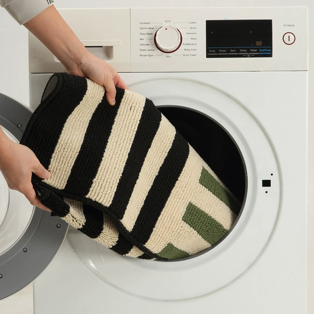 Machine-washable care demo for the Soren Cream Black Block-Stripe Textured Rug by Housenfriends