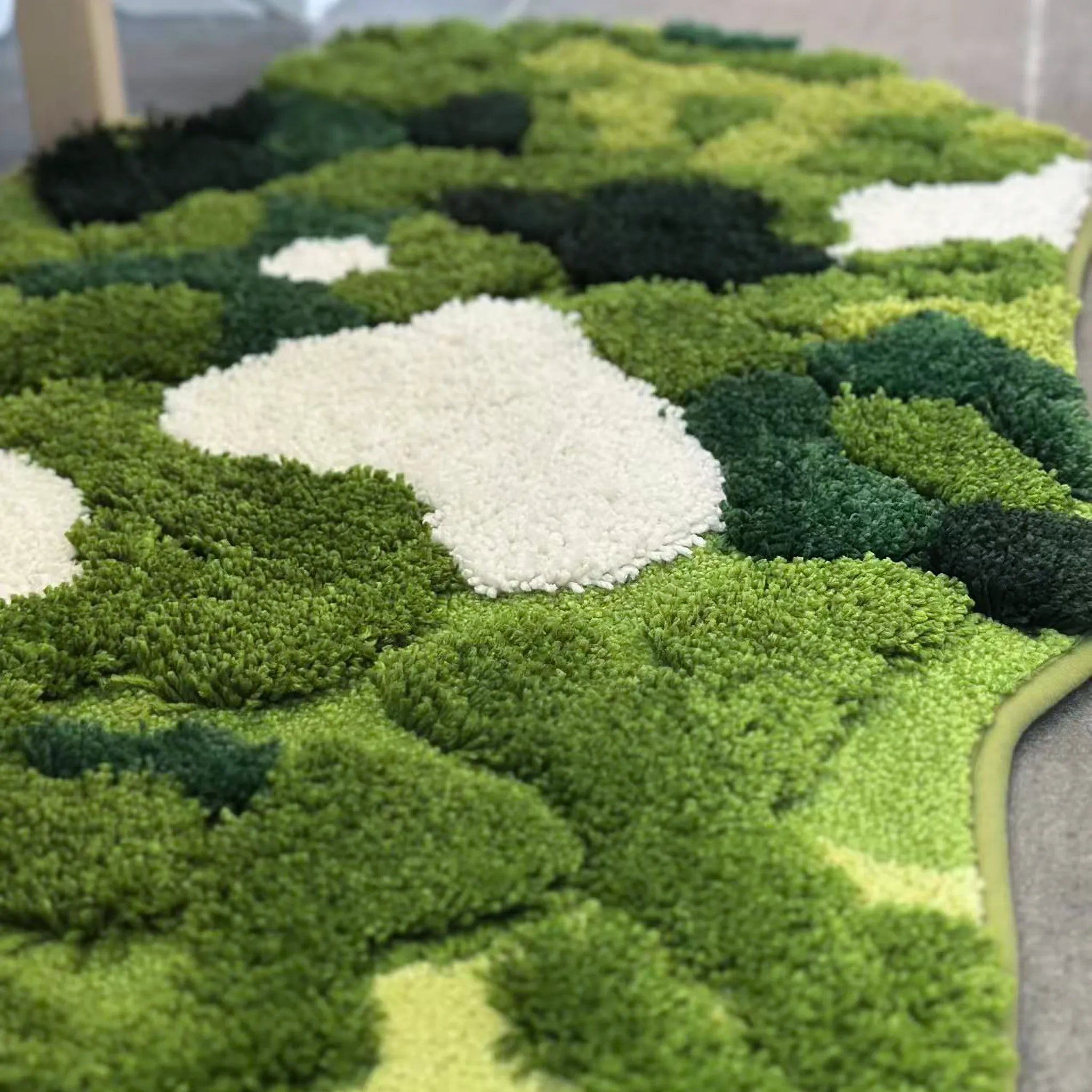 Close-up of Sylvie forest moss green tufted high-low pile with off-white highlights by Housenfriends