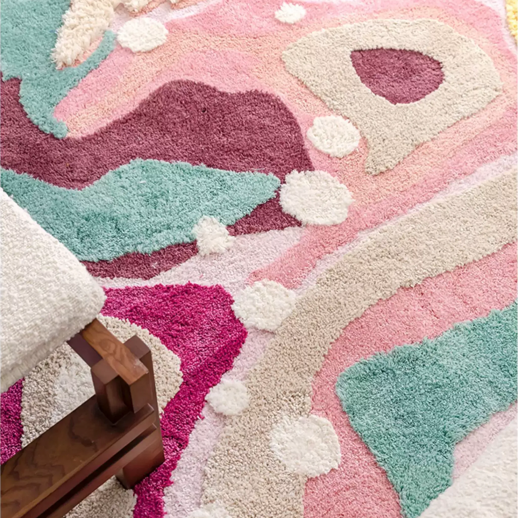 Close up of Willa pastel abstract rug with pink, aqua, cream and berry colour fields, showing soft high-low tufted texture