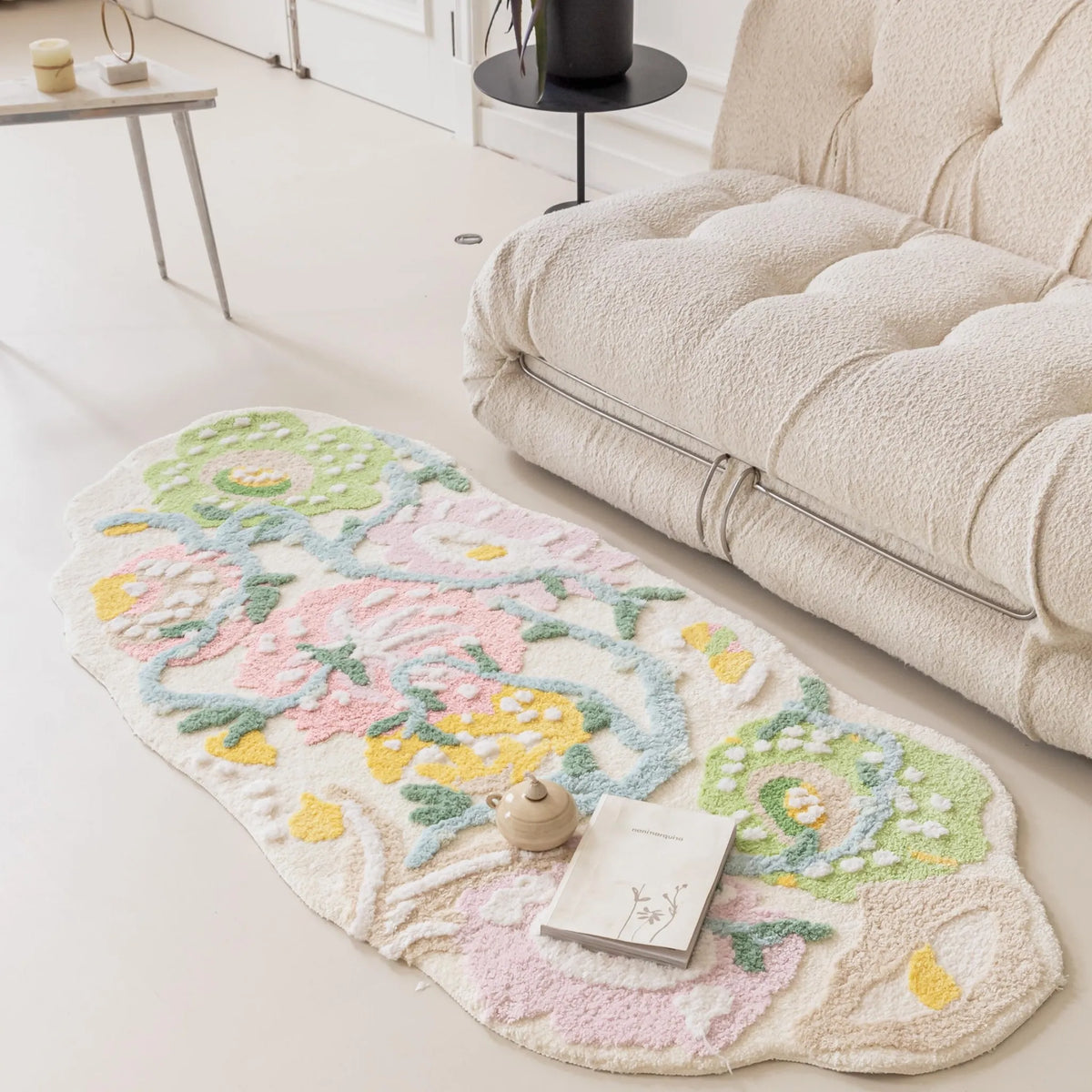 Housenfriends Celia pastel floral irregular runner rug in pink, green and yellow beside a cream sofa in a bright living room.