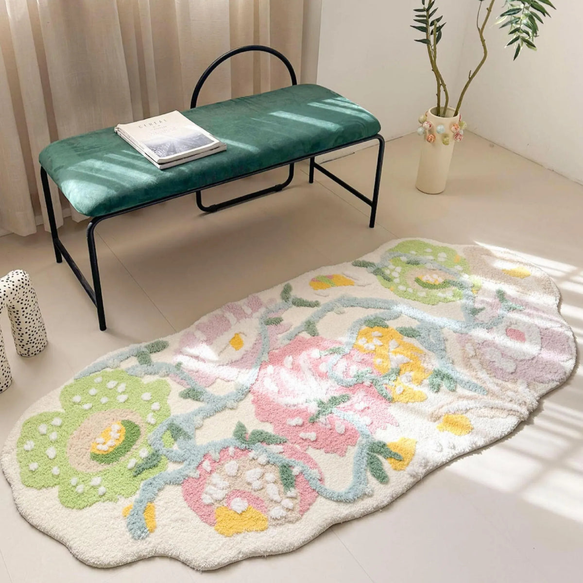 Housenfriends Celia pastel floral runner rug with an irregular outline beside a green upholstered bench in natural sunlight.