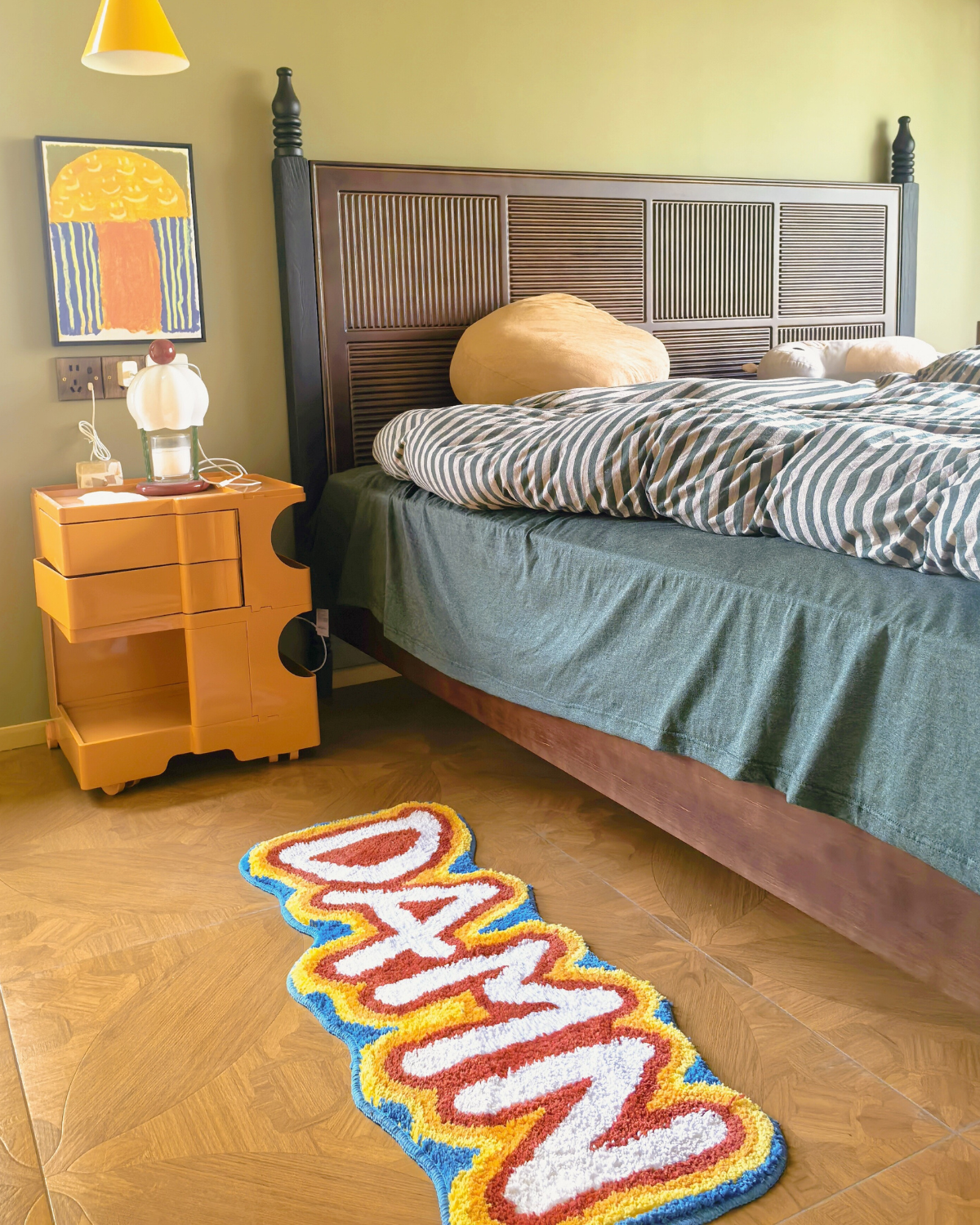 Housenfriends Damn rainbow shag rug beside the bed in a colourful eclectic bedroom.